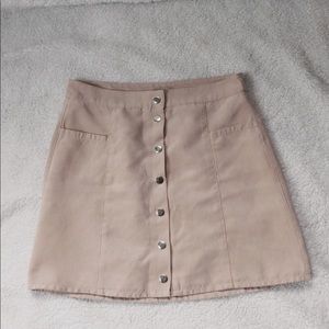 A pink skirt with buttons down the front
